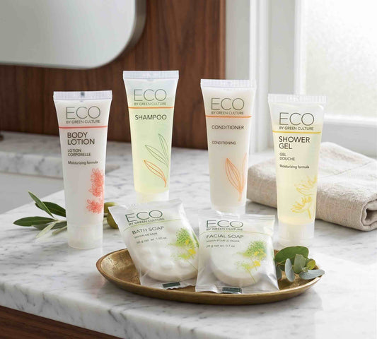 Eco By Green Culture hotel amenities displayed on a bathroom counter with towels and greenery.
